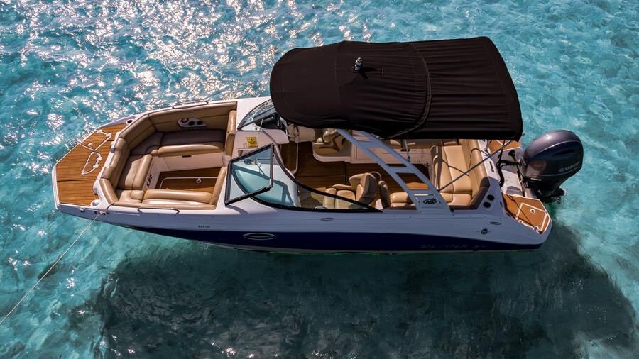 Nautic Star 25 ft day boat anchored in clear water off Miami Beach