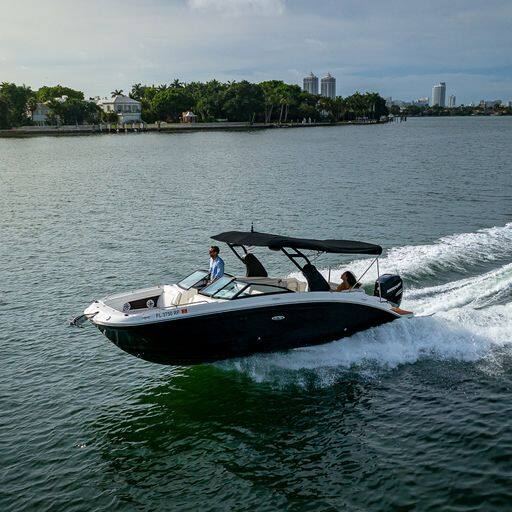 Sea Ray 29 Creed 2 sport cruiser underway with the Miami skyline behind it